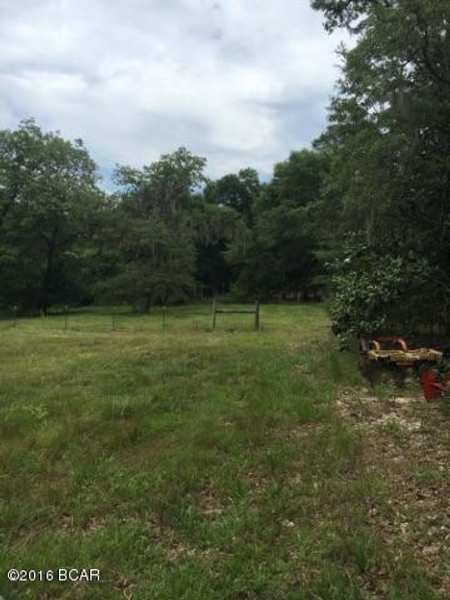 26 +/- acres with Hwy 77 frontage. 24 x 36 barn PLUS 24 x 26 add on that is closed in. 2nd building is metal building with concrete floor. Plenty of storage space. Property is fenced. Plenty of room to build your dream home up on hill in back with lots of privacy and what a view and still have room to garden, have horses, and enjoy quiet country living!