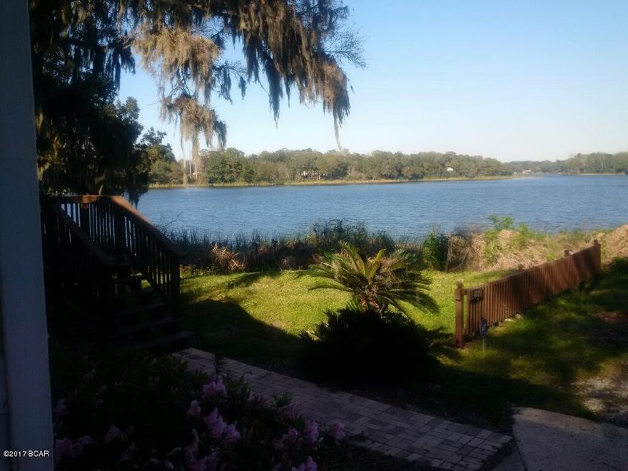 WATERFRONT! Immaculate beautifully maintained modular home located just 4 miles from downtown PC comes with it's own private dock, covered deck  incredible oaks, and is elevated to take advantage of the amazing views of the lakefront. It has new pavers for it's walkway with an L shaped stairwell entry. There is a new carport and 12x24 shed w/loft. The shed has a split entry which is powered, closed cell insulation and is finished with Pergo floors as well as with a/c and heat. Designed to be a private office, exercise room or private guest room. This home has it all, new faux wood blinds, alarm and sprinkler systems, vinyl plank flooring and beautiful 'be paint. There is room for multiple boats and RV's on this property where you can live next to the Lake Martin Florida Birding Trail. An anglers dream home because Lake Martin is famous for the area's large bass. You are so very close to East Bay  and Crooked Island/ Mexico Beach are not far across the Dupont Bridge either. You can own the whole side of the street from the lake to the stop sign and have nothing but beautiful Heron for your neighbors. This is a Precision Home of the highest quality and is rated C140 for wind. 

 2002  Survey on file please call to see. This property for sale consists of 3 parcels  all being 51' feet wide and going the entire length of Magnolia from Horne. Unbelievably gorgeous property has 3 separate addresses 402, 408, and 410 Magnolia Street. 
 Owner may consider selling only the parcel with home on which adjoins the water. 
All measurements are approximate so please measure to be sure if important to you.