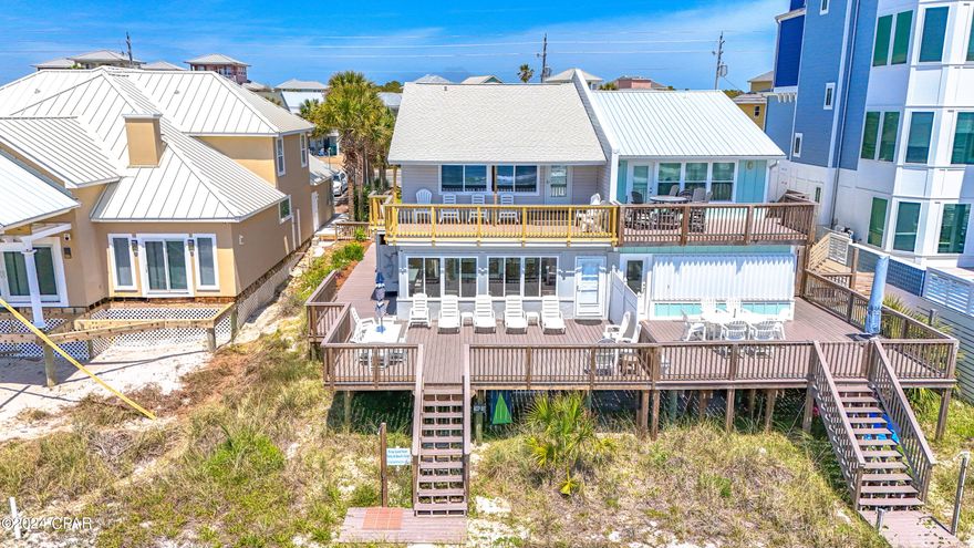 CURRENTLY UNDER CONTRACT, SELLER WILL CONSIDER BACKUP OFFERS. Don't miss your opportunity to own this rare single family beachfront property. Situated directly on the Gulf of Mexico! No HOA, no elevators and no offsite parking garages. This stunning 4-bedroom, 3-bathroom home offers breathtaking views and tranquil gulf breezes. With its spacious layout this property is perfect for entertaining family and friends but intimate enough for a getaway for one or two couples. Just 5 minutes from Scenic Hwy 30A's dining and entertainment. And only 10 minutes from Pier Park and its shopping, dining and clubs. Publix and Winn Dixie are less than 1 mile away.  So, you can stock up upon arrival and never have to leave your beachfront oasis. 
The home boasts a main living area with an open floor plan. Nine-foot ceilings and an abundance of new windows allow natural light to flood the space. Enjoy seamless transitions from kitchen and dining areas to the living room and sunporch. This continues to the outdoor living space of the expansive deck that provides the perfect spot for al fresco dining, sunbathing, or watching the sunset over the emerald waters of the gulf.
The kitchen features granite countertops, stainless steel appliances, bar seating and ample cabinet space. Whether you are hosting a dinner party or preparing a family meal, this kitchen is fully stocked and ready. The open kitchen design with elevated bar lends to the area being a common gathering place to socialize. 
Thoughtful planning made sure there was a large king bedroom with ensuite bath on the first floor.  The second floor has 3 bedrooms and 2 full bathrooms.  One king room and two bedrooms containing 2 queen beds each. The south bedroom, with its 12 feet of widows and unobstructed gulf view, opens to a 275 sf deck on which to enjoy morning coffee or sunset wine and cocktails. 
Outside amenities include two showers. One is private with hot and cold water.  A favorite of everyone who visits!  Stationary Charcoal Grill. There is plenty of parking and a lock out storage room off the carport. The deck and balcony are low maintenance composite lumber. 
The home also features new high impact window, Porcelain floors, and Stainless Steel appliances. Full HVAC replacements in 2018 of both units. Water heater 2019. Roof 2015. 
Make an appointment now to view your forever beach oasis or short-term rental investment property! Offered fully furnished with a strong rental history and future booking of new and repeat visitors. 
BUYER TO VERIFY ALL IMPORTANT INFORMATION
