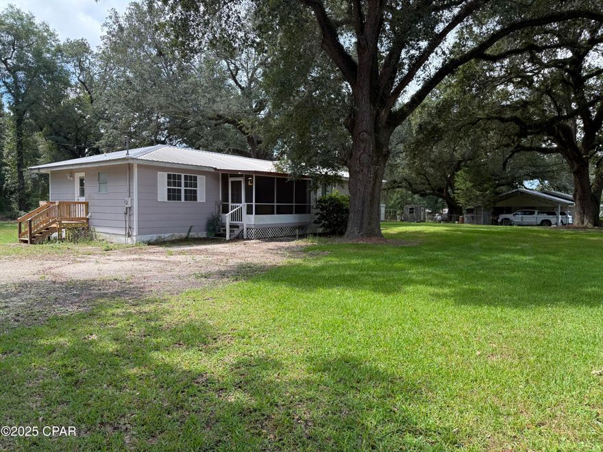 Enjoy peaceful country living just 6 minutes from the charming small town of Malone, FL. Nestled among beautiful live oak trees, this 3-bedroom, 2-bath home offers a quiet, serene setting right off a paved road. The spacious layout features a large open kitchen and living room, a formal dining area, and generously sized bedrooms.  Relax on the large screened front porch or the screened back porch while overlooking the completely fenced backyard—perfect for pets, play, or gardening. The property also includes two storage buildings for all your tools and equipment.  Recent updates include a metal roof (2018), updated electrical (2018), and a brand-new hot water heater. This home blends comfort, convenience, and country charm—ready for you to move in and enjoy! Make an appointment to see all this property has to offer.