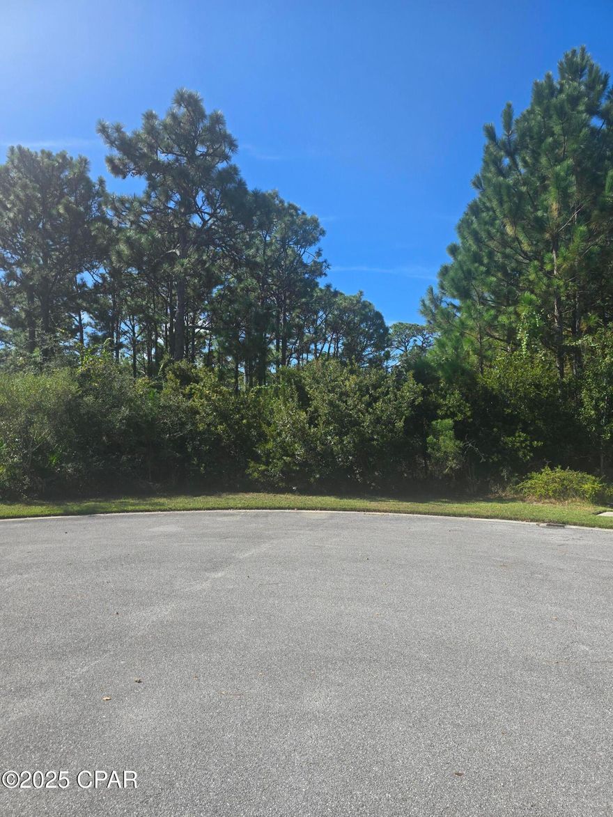 LARGE Nearly half-acre building lot in exclusive gated community of Trieste.  Situated on a cul-de-sac and surrounded by beautiful Mediterranean style homes, this is a one of a kind opportunity.  Trieste is a hidden gem tucked into a wooded / gated community, convenient to Pier Park and next to Gayles Trails, with paved trails for bikers, runners, walkers and nature lovers!  The School district is highly desirable for all age students.  Build your dream home on this large, secluded private community lot.   All info is approx and must be verified by Buyer. Make an appointment to see this beautiful lot today!