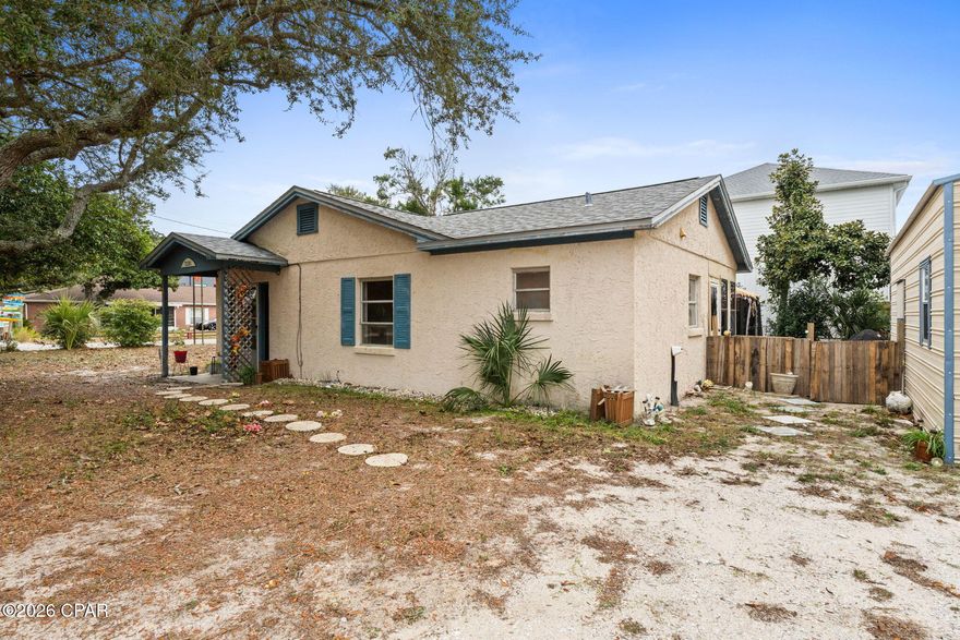'CURRENTLY UNDER CONTRACT, SELLER WILL CONSIDER BACKUP OFFERS. Situated in the heart of Panama City Beach, this property offers a rare blend of investment potential, location, and privacy--all within walking distance from the sugar-white sands of the Gulf of Mexico. Whether you're searching for a primary residence, second home, or income-producing opportunity, this home checks the boxes that matter most.

Set on a large lot shaded by mature trees, the property provides a peaceful, serene setting while still being close to everything PCB has to offer. The expansive yard offers plenty of room to expand, add outdoor living space, or simply enjoy the natural surroundings.

A detached garage adds versatility and value--perfect for storage, a workshop, beach toys, or parking. With 3-bedroom, 2-bathroom home with nearly 1,300 square feet provides plenty of comfortable living space.

Conveniently located near top-rated schools, popular dining, shopping, and entertainment, and just a short drive or bike ride to the beach, this home offers everyday convenience paired with coastal lifestyle appeal. Its proximity to major attractions and the Gulf makes it especially attractive for a primary or rental.