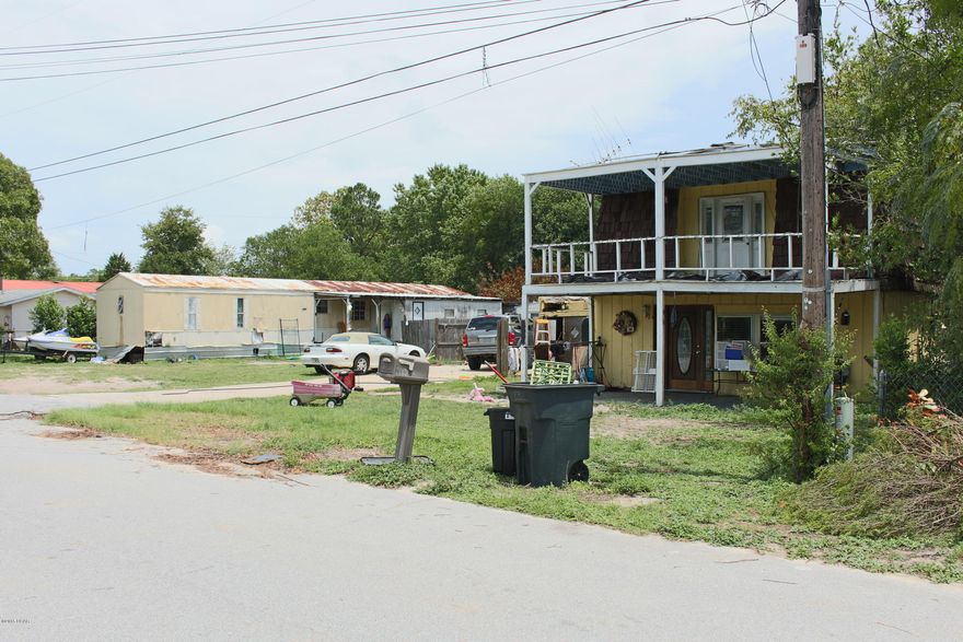 TWO PROPERTIES FOR THE PRICE OF ONE!!  This could be a great investment for you.  There is a 2-story 4-bedroom (3-bed up, 1-bed down), 2-bathroom (1-bath up, 1-bath down) house on one lot.  Then there is a trailer with 4-bedrooms and 2-bathrooms on the other lot.  There are two separate lots with one residence on each lot.  The seller lives in the house and the trailer is vacant right now.  This could be a rental machine for you.  Come see this property today!