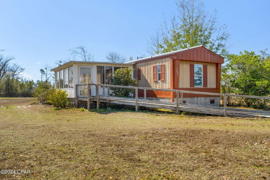 CURRENTLY UNDER CONTRACT, SELLER WILL CONSIDER BACKUP OFFERS'...This mobile home has been converted into a 2 bedroom/2 bath.  Located off a paved road in Flood Zone ''X'' and R2 Zoning, this cozy home sits on a little over 1/2 acre, so, there is plenty of room to add a workshop, pole barn, etc.  Whether you're relaxing in the sunroom or on the deck, you're sure to enjoy that sunshine.  HVAC has been serviced yearly and Roof is 2019.  Get with your favorite realtor today to schedule your showing.  If measurements deemed important, please verify.
