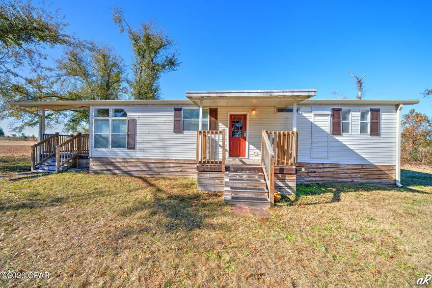 Beautifully updated 2 bed, 2 bath mobile home on a peaceful 14+ acres with an established horse barn and multiple storage sheds nestled off Highway 231. This property is located on a paved road outside of the hustle and bustle of living in town but still conveniently located near shopping, churches and schools. This home features a large living room adorned with beamed ceilings. The dining area boasts large windows allowing for plenty of natural light to illuminate the room. The kitchen is equipped with white shaker cabinets, granite counters and stainless appliances. The spacious master bedroom has double closets and a private ensuite. The master bathroom features a shower with sliding glass doors and lots of counter space. There is an additional bedroom and bathroom with a shower/tub combo. There is a pole barn for RV or boat parking. Washer and dyer will convey. This property offers plenty of space where the outdoor opportunities are endless!