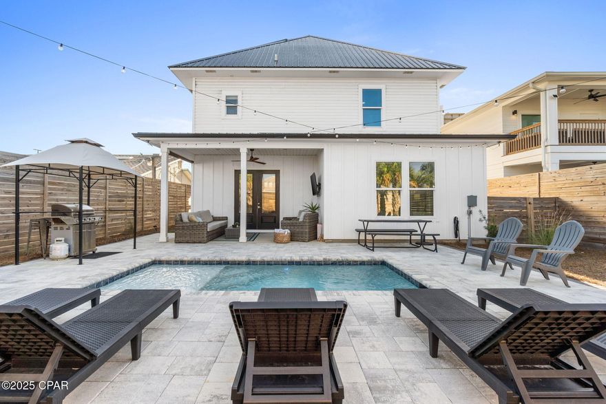 A premier investment and luxury coastal retreat, this custom beach home is positioned just a short 5-minute walk from Public Beach Access 15 and the iconic emerald waters of Panama City Beach. Purposefully designed to host large groups, it sleeps up to 19 guests and delivers impressive rental projections exceeding $130,000 annually. The open main level showcases a gourmet kitchen with granite countertops, stainless steel appliances, and walk-in pantry flowing seamlessly to the covered patio, private pool, and outdoor shower. The primary suite provides resort-style comfort with a soaking tub, walk-in shower, and spacious closet, while multiple bunk rooms including a third-floor bunk suite with lounge area enhance rental versatility. A second-floor family room with a wet bar opens to a sunset-view sundeck ideal for entertaining. Perfectly located on the desirable East End near local favorites like Schooners and FINNS Barista Bar & Snack Shack, this fully furnished property offers superior guest appeal and proven performance in one of PCB's strongest rental corridors.