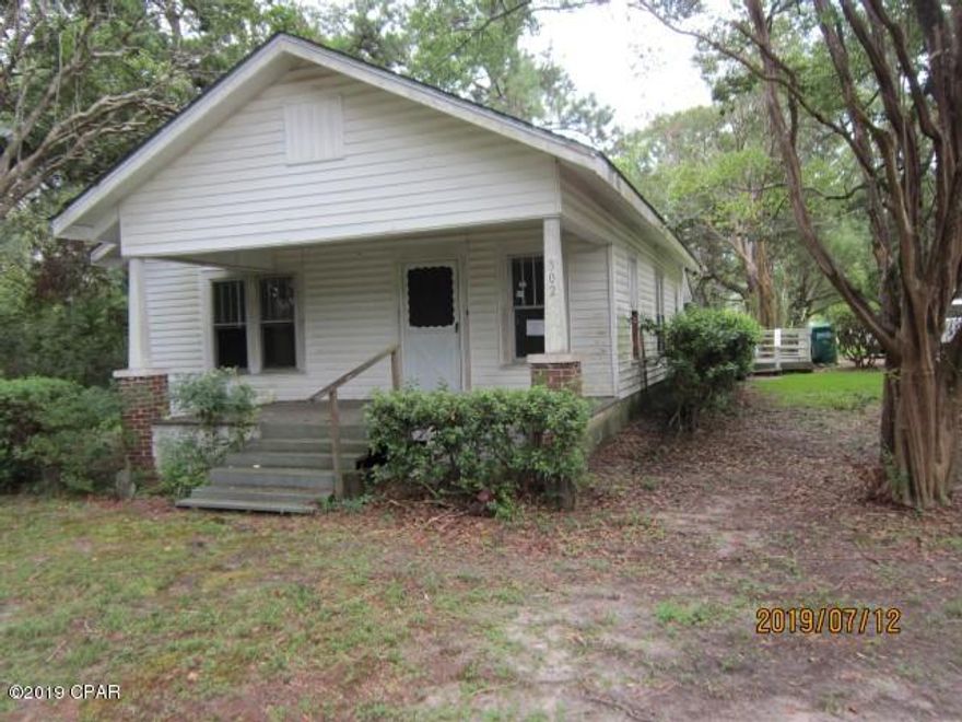 Older home, frame with vinyl siding, in Bonifay City Limits, 3 bedroom 1.5 bath.  the back bedroom, half bath and laundry room  were created by closing in a former back porch.  Home features a large covered front porch and a back wood deck with railing.  House has a fireplace in the front bedroom and the middle bedroom fireplace has a gas space heater installed on the hearth.  House has large Living/dining room combined, with laminate flooring,  and an adequate sized kitchen.  Total footage is 1082 of living space.

House appears solid but will need some work, especially closets space added to bedrooms, old windows replaced, bathroom tub, flooring repair, and other items. Roof has  blue tarp but may can be repaired.  House is under the Freddie Mac First Initiative, ask your realtor.