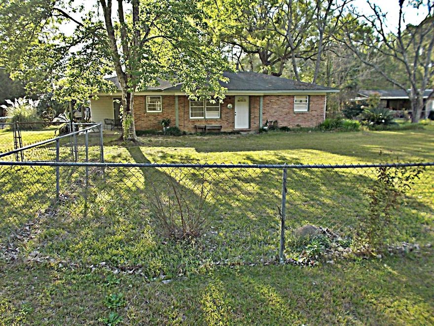 Ideal home for retirement or starting out, this cute brick house is in town and has city water and sewer, has had some updates and is in very good shape it appears, the previous owner took down a partial wall to make it a 2/1 but if you need 3 bedrooms it would be very simple to replace it. There is a one car carport and a utility room also. All of  the yard is fenced and has a workshop in the back. Living/dining room is open floor-plan to make it seem larger. Priced to sell.
