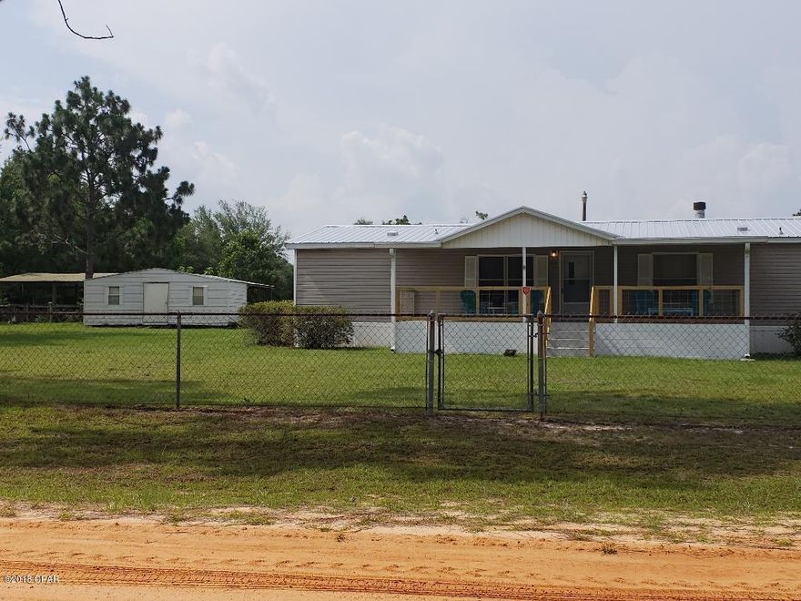 ROOM FOR YOUR HORSES, WITH A BARN. COMPLETELY FENCED IN!!! NEW METAL ROOF, COVERED PARKING. HOME HAS TWO VERY LARGE COVERED PORCHES!!