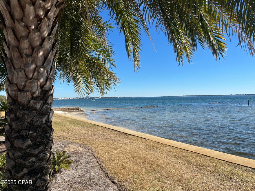 : Own your own piece of paradise on St. Andrews Bay. This is a well maintained, furnished property .  Wake up each day with breathtaking bay views from your balcony or from your sandy beach area in Landmark Condominiums. The Community boasts a private marina, a workout room, bicycle storage, canoe storage, large covered cook out area with gas grills, tables and TV for your enjoyment. A beautiful Club house that overlooks one of two pools and the bay. Clubhouse has restrooms, a full kitchen, seating and tables for your private parties or family get togethers. This condo is one of a kind and has been totally updated to include all electrical and plumbing (2019). Home boasts an open concept kitchen with an abundance of cabinetry with corian counter tops. Breakfast bar and room for a large kitchen table, Stainless steel appliances that consists of a stove, decorative hood vent, dishwasher, side by side refrigerator and microwave. Unit has a stackable washer and dryer along with a new water heater. The interior has vinyl plank flooring throughout the home with the exception of both bathrooms which have upgraded tile floors and designer tile showers. Master bedroom is large and has a large closet, recessed lighting and plantation shutters. Bedroom 2 has plantation shutters, pull down stairs for attic storage and a large closet. Plenty of storage inside and out on the beautiful bay front property. Endless possibilities with living on the water and close to down town amenities. Call for your personal showing today