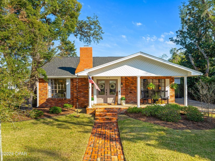 This beautifully renovated ranch-style home in the historic Bunkers Cove neighborhood offers a lifestyle of comfort, convenience, and charm.

Under a new roof, this brick-built single-story cottage harmonizes timeless appeal with modern convenience. A brick-paved path welcomes you to the front porch and through double front doors into a home filled with character. Original hardwood floors and a gas brick fireplace set the tone in the cozy living room, dining area, and bedrooms.

The oversized chef's kitchen is a showstopper, featuring new LG appliances, a stunning brick accent wall, and a honeycomb tile backsplash. Each bedroom offers custom closets for ample, organized storage, while fresh paint throughout the interior and exterior enhances the home's appeal.

The nearly quarter-acre lot is fully fenced for privacy, creating a safe haven for pets and children. Outdoor living shines with a spacious covered living area, a paver patio, and lush new sod complemented by an updated irrigation system.

Parking and storage are effortless, featuring driveways at both the front and rear with ample space for boat or RV parking, along with a pull-through oversize carport.

Situated in a golf-cart-friendly community established in 1907, this home is conveniently close to Tyndall Air Force Base and downtown Panama City. Boaters will appreciate the proximity to St. Andrew's Yacht Club and the serene waters of St. Andrew Bay.