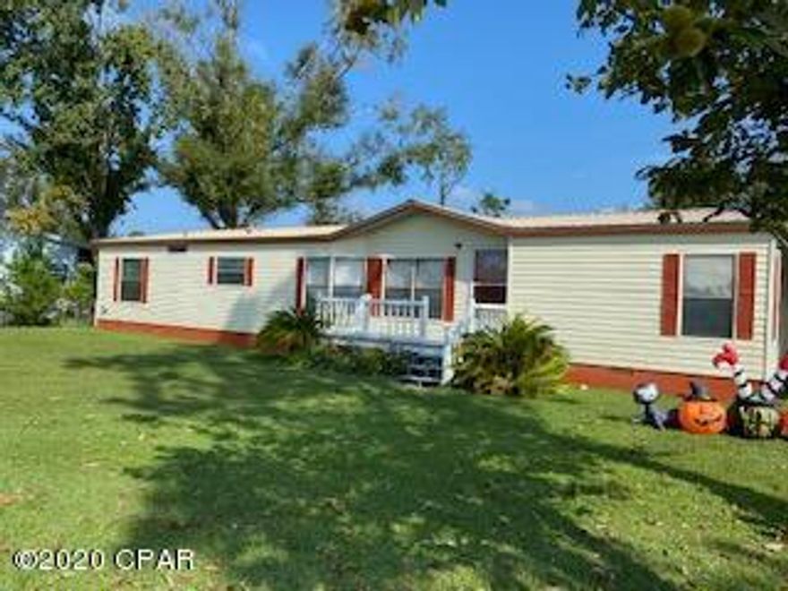 UNDER CONTRACT SELLER TAKING BACKUP OFFERS!  Great location! This Nice Double Wide is on a spacious corner lot, the home features a metal roof, enclosed back porch/sunroom, nice front deck and back decks, the fenced in back yard has a large  storage building and 2 car carport. When you step inside you'll notice the open floor plan, large kitchen with eat in area, spacious great room with dining room and theres additional living room with double sided wood burning fireplace. Split floor plan offers a large master suite, with separate shower and tub with a spacious walk in closet. Theres 2 additional bedrooms and another bath on the opposite side of the home. Large laundry room has space for a freezer and offers a door to the sunroom and back deck. Please verify measurements if important