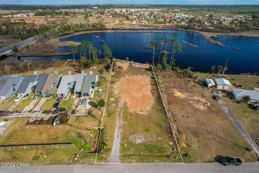 Beautiful waterfront vacant land expanding 107' in total. This property is only 7 miles from Tyndall Air Force Base, 26 miles to Northwest Florida Beaches International Airport (ECP), and a short & sweet 16 miles to the worlds most beautiful beaches. This location has already been pre-engineered and pre-approved by the City of Callaway Development Order for a 12,200 square foot six condo project, or three townhomes. Taken out by Hurricane Michael, previously there did sit a home that was 3500 square feet, however there is more than enough room to build a home up to 5000-6000 square feet, including a pool. Water, sewer and power on site.