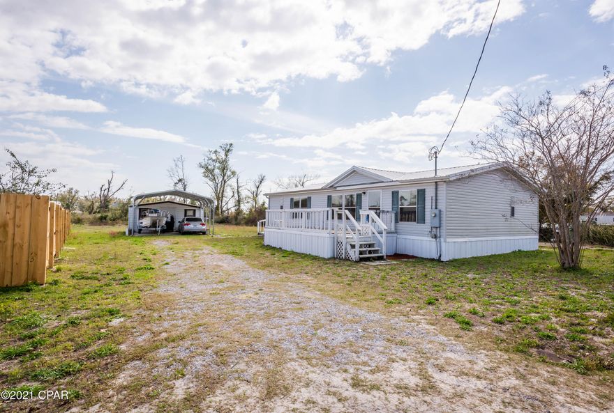 CURRENTLY UNDER CONTRACT, SELLER ACCEPTING BACKUP OFFERS.  NOW ACCEPTING VA FINANCING!! Close to Tyndall Air Force Base-6 miles from main gate. Don't miss your opportunity for affordable living with plenty of space for your toys with more than 1/2 an acre of ground. Two storage sheds.  Open concept and spacious living.  There is a covered carport area for two cars, plus a concrete parking pad to the right of the home.  Home has a metal roof, installed in 2018.  Generous closet space, including a walk in closet.   Comes with push lawnmower, weed eater and other lawn items.  Measurements are close, but please verify if you need exact.