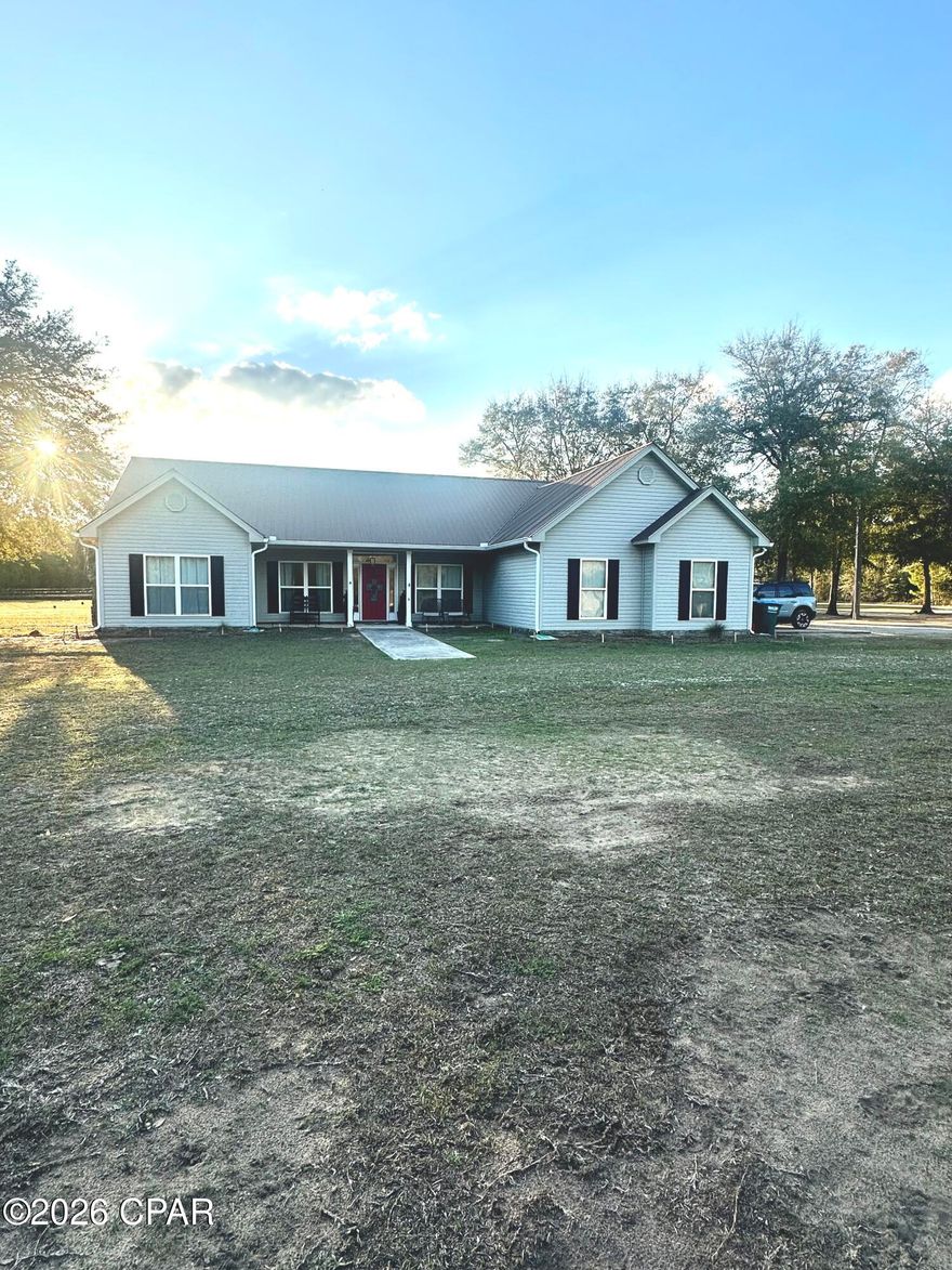 This well-kept home sits on 5 open acres, giving you plenty of space while still keeping you close to what you need. Panama City and Dothan are about 45 minutes away, Tallahassee is an hour out, and the beaches of northwest Florida are just over an hour from your front door.

Inside, the home has tasteful updates from the last few years. The open layout feels fresh, comfortable, and easy to enjoy.

Outside, the property offers even more. One pole barn is set up for boat and ATV storage, with room for tools and animal supplies, plus an RV hookup. The second pole barn includes an 800-square-foot apartment with 2 bedrooms, 1 bath, and a large porch perfect for sunsets and relaxing evenings.

For anyone interested in animals or a small homestead, the land is ready. Two fenced pastures--one with running water--can support small livestock. A working chicken coop sits in the fenced backyard, and the hens are already laying eggs.

This property offers peaceful privacy with open space, yet town amenities are only a short drive away. With thoughtful updates and room to grow, it's a place that feels warm, inviting, and easy to call home. All measurements are approximate; please verify if needed.