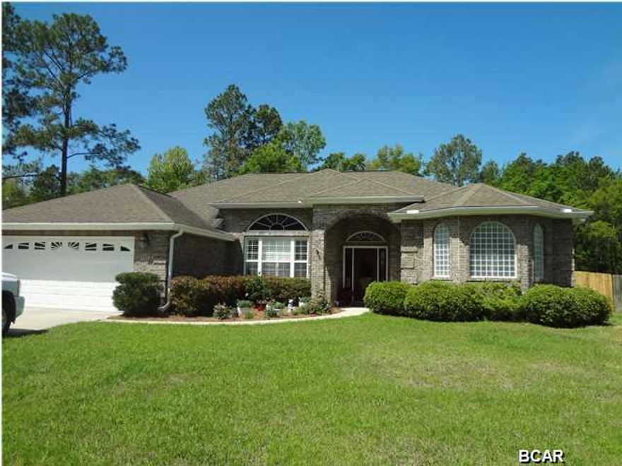 Beautiful four bedroom, three bath home located in The Landings of Lynn Haven. You'll appreciate the high trayed ceilings and open floor plan this home provides. Wonderful kitchen with breakfast bar, solid surface counters and bountiful cabinetry, overlooks family area and adjacent dining area. Split bedroom plan allows for privacy and master suite offers two huge walk in closets and a master bath that will overwhelm. Owners have replaced all flooring with hardwood and tile, along with new tank-less hot-water system, dishwasher, stove and stainless double door refrigerator. The back patio is perfect for entertaining and overlooks privacy fenced back yard. Plenty of room for a pool! Sellers are providing a One Year Home Warranty, existing survey and current termite bond. Call to see