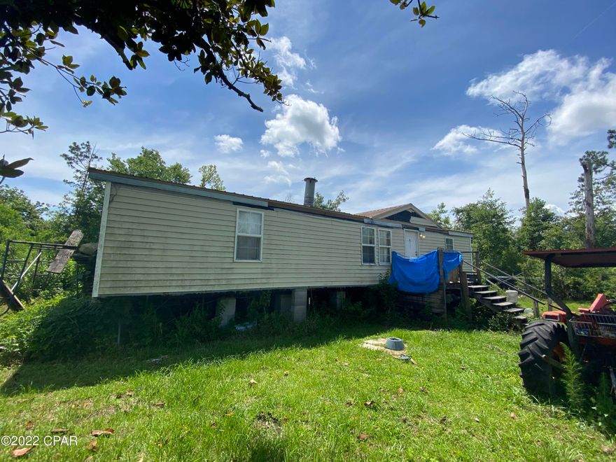 Property is being sold in as-is condition. Location, location, location. Home does need a bit of work, but is located just a stones throw away from a major housing development. This would make a great live-in project for a handyman. Metal roof installed after Michael, Central heating and air unit less than 4 years old, and working bathroom. Would make a great project for the right buyer.