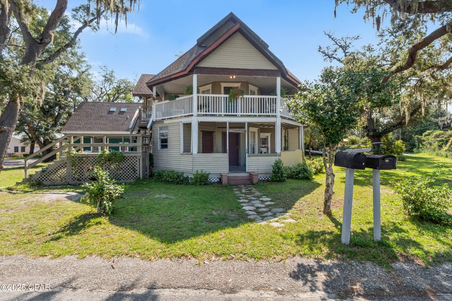 More than just a home, this victorian inspired-style property is the opportunity to create your own vision while maintaining a piece of authentic Florida history. Built at the turn of the 20th century, it has had a succession of eminent owners and custodians over the past 125 years, each contributing to its character while retaining its historic distinction. Heralded as one of the ''finest Victorian eclectic-style houses in Panama City,'' it is probably the only Folk Victorian home on the market in the city. This beautiful treasure stands proudly on an expansive quarter-acre corner lot beneath mature live oaks draped with trailing Spanish moss. Just a short walk from St. Andrews Bay, this remarkable home boasts water views from the second floor. Traditional balconies and porches provide generous areas for relaxing, reading, and entertaining, with fresh breezes enhancing the alfresco lifestyle. The first floor has been taken down to the studs and is ready for your vision, while the generous living spaces and multiple sleeping accommodations make this grand home versatile--ideal for a multi-generational family or a variety of other uses.The charming two-bedroom carriage house on the property provides a rental income potential from day one. The door opens into an open living room with wood flooring, a well-equipped modern kitchen, and a comfortable living room. Two bedrooms include a light-filled first-floor bedroom with large windows and a built-in closet. The second-floor bedroom oozes charm and character with skylight windows for stargazing and doors opening onto a small balcony. A modern bathroom with antique-style black fittings transitions old and new. Those looking for a prestigious home that's completely out of the ordinary with a legacy of history and opportunity will find this residence checks all the boxes. Located in the sought-after Beach Drive neighborhood, the home is currently pending a Historic Marker, requested by the Panama City Historic Society to be placed as part of the Sidewalk Improvement Project. This unique home is within easy walking distance to downtown coffee shops, restaurants, breweries, parks, festivals, and the farmers​​‌​​​​‌​‌​​​​‌​​‌​​​​‌‌ market.