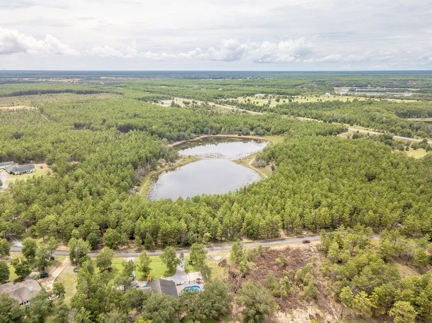 Waterfront Privacy on over 5 acres! This nicely wooded waterfront parcel provides approx 800' of frontage on a +/- 10ac Lake.  Choose from multiple homesites and enjoy the privacy of Country Living with only a short driving distance to Panama City!