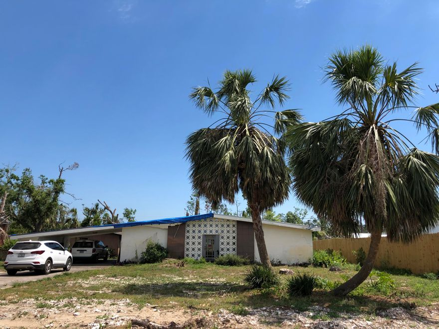Great sought after St. Andrews area near W. Beach Drive and the favorite walk, jog, strolling area in Panama City!  The breeze from the pass makes this a favorite as does the closeness to downtown and St. Andrews locations!   This home has moderate damage from Hurricane Michael and is priced to renovate.   Roof has been tarped and sheet rock removed in most rooms  down to the studs.  Block construction with an open floor plan.  The kitchen/dining area has sitting area also.  Central atrium  with diffused  natural light and cooled patio/garden area. Settling slab quote to level and guarantee stabilization $15000-$20000,  Custom plan and and is quite unique.  Home is sitting on two 50 ft. lots with option to build 2 homes . Updating and rebuilding being done in the surrounding area!