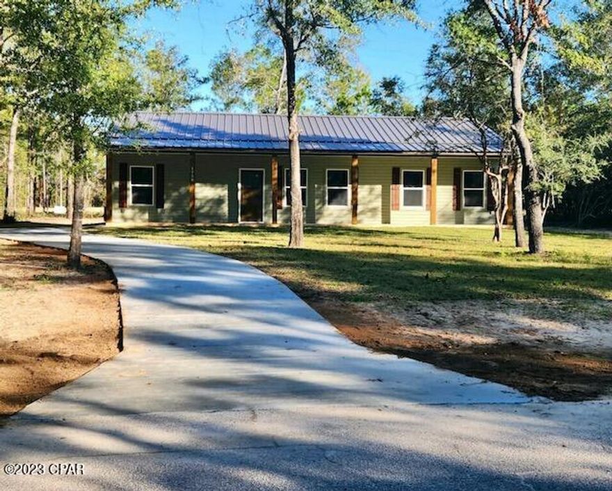 CURRENTLY UNDER CONTRACT, SELLER WILL CONSIDER BACKUP OFFERS! Introducing this remarkable brand new construction in the thriving Sunny Hills community! This charming southern farmhouse-style home is located on a paved road and sits on a stunning golf course lot, offering breathtaking views overlooking the 12th fairway. The eco-friendly, all steel construction is not only durable but also environmentally conscious, as 67% of the materials used are recycled. Step onto the large, full-length front porch that welcomes you home and relax under the ceiling fans on the back porch while sipping your favorite beverage. The metal roof and vinyl siding not only add to the home's aesthetic appeal but also ensure low maintenance and longevity. Enjoy the convenience of 9 ft. ceilings and keyless entry, adding modern touches to your living experience.  Inside you'll find a thoughtfully designed layout with modern amenities and luxury features. The closed-cell foam insulation in the roof and walls keeps the home energy-efficient, providing you with comfort all year round. The stainless-steel Whirlpool appliances, including a side by side refrigerator with water and ice maker, complement the sleek and functional soft-close plywood cabinetry. The large walk-in pantry and laundry room offer convenience and practicality for your everyday needs. The central heat/air system with a heat pump keeps the interior cozy and comfortable. You'll love the continuity and durability of the luxury vinyl plank flooring that spans throughout the entire home. The elegant granite countertops in the kitchen add a touch of sophistication to your culinary endeavors in the open-concept living space.  Rest and relax in the spacious master bedroom, complete with a walk-in closet, providing ample storage space. 
Beyond the beauty of your new home, the community also boasts several large lakes and a swim park, perfect for leisurely activities and family outings. Additionally, being located approximately 45 minutes away from the world's most beautiful beaches allows you to enjoy coastal pleasures whenever you desire. 
Rest assured, this home meets all current Florida building and energy codes, ensuring the utmost safety and efficiency. Furthermore, the high-quality construction and eco-friendly features qualify for some of the lowest insurance rates in the area, giving you peace of mind.  Don't miss this opportunity to own a beautiful, environmentally conscious home in the sought-after Sunny Hills community. Experience the perfect blend of luxury, comfort, and natural beauty in this exceptional property!