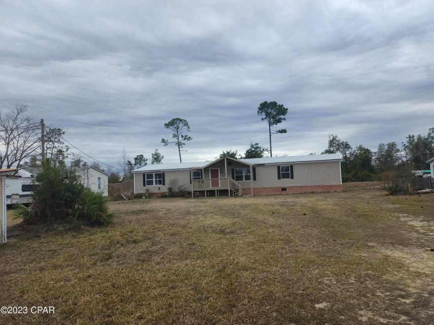 CURRENTLY UNDER CONTRACT, SELLER WILL CONSIDER BACKUP OFFERS Want to feel like you are in the country but only 20 minutes from downtown and 30 minutes to the beaches, here is your chance.   This three-bedroom, two bath home sits on just under an acre, has an open floorplan and new LVP flooring throughout.  A very nice covered front porch offers comfort and protection upon approach and entry. The 16' X 13' kitchen has a great deal of storage space and includes lots of cabinets, a food pantry and built in shelving.  The split floorplan design provides privacy and each of the 3 bedrooms include a walk-in closet. Measurements are approximate, buyer to verify.