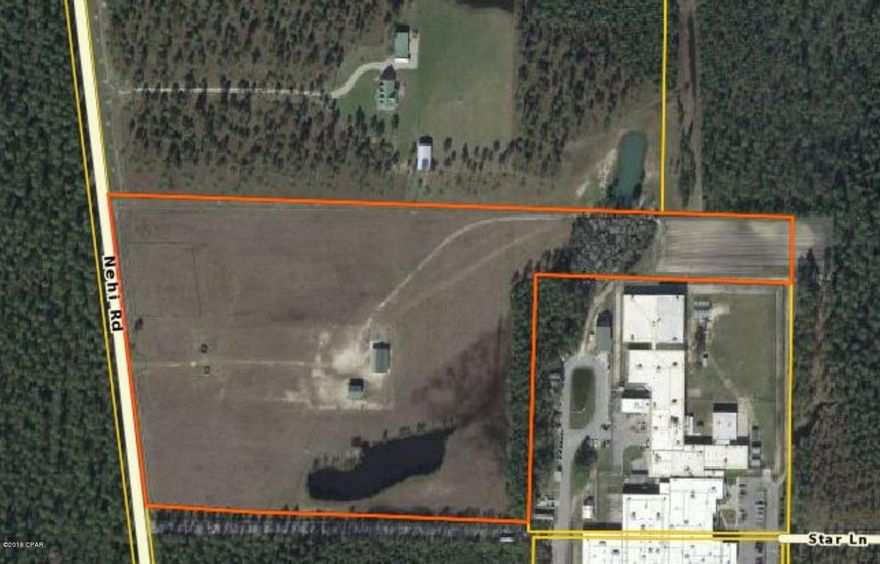Excellent residential opportunity: 20 Acres centrally located, convenient to Hwy 231 and East Bay County. The property is completely  cleared, fenced.  This is an excellent location for an equestrian center and offers a one and 1/2 acre pond on the property. The property is also leased but can be canceled with 90 days notice to Bay County.   Sewer and water are available on NEHI road.  Pond was permitted by Tristate Land and Timber, approx 1.5 Acre.  (Stable belongs to jail and will be removed unless seperate purchase negotiated)