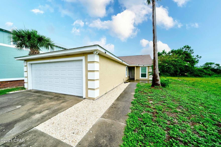 Location! This beautifully renovated three bed, two bath home is just a short walk away from the beach!  Upon entering, you will notice the open concept kitchen with quartz countertops, stainless steel appliances, and a plethora of white cabinets for storage.  The huge living area features recessed lighting, a large arched window to brighten the room, and enough space for a dining area. The master bedroom boasts vaulted ceilings and its own luxurious private ensuite.  The master bathroom features a soaking tub, a double vanity with his/her sinks, and a separate tile shower. The additional two bedrooms share a bathroom that boasts a shower/tub combo with sliding glass doors and plenty of cabinet space. The separate laundry room, with a large utility sink, leads to the two car garage for your convenience. This home has a secluded backyard area with a gorgeous pool and an extended pool deck to enjoy the Florida sun with family and friends. This home is located in a safe and gated community with no traffic.  Enjoy the convenience of being near plenty of restaurants, beaches, and shopping centers; including the well-desired Pier Park area. All furniture is negotiable!