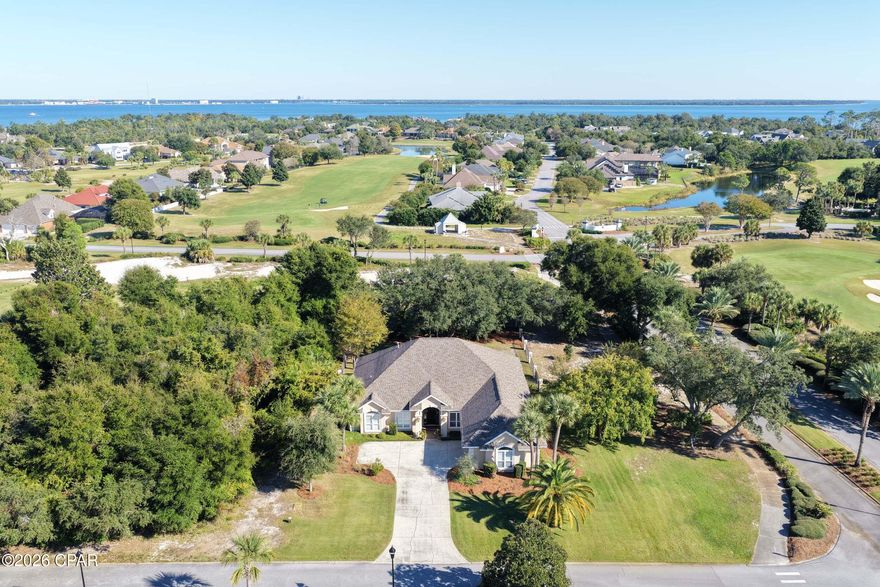 Rare opportunity to own a beautifully maintained one-owner home overlooking the Jack Nicklaus Golf Course in Bay Point. With 10- and 12-foot ceilings, crown molding, and walls of natural light, this spacious single-story home offers an open, airy feel throughout.

The thoughtfully designed layout includes 3 bedrooms, 2 full baths, a dedicated office (or optional 4th bedroom), and a 2-car + golf cart garage. The primary suite features his-and-her closets and private access to the covered porch, creating the perfect retreat. Multiple living areas flow effortlessly for entertaining, including a welcoming family room open to the eat-in kitchen and a separate dining space that connects to an additional living area. A private office off the foyer is ideal for working from home.

Situated on a beautiful corner lot, the fenced backyard is a peaceful oasis with mature oak and magnolia trees providing shade and privacy.

Located inside the gated Bay Point community, residents enjoy access to championship golf, a full-service marina, Neon's Bar 72 Restaurant & Bar, and close proximity to boating, dining, shopping, top-rated schools, and the sugar-white beaches of Panama City Beach.

Homes in Bay Point rarely offer this combination of space, location, and one-owner care--schedule your private showing today.