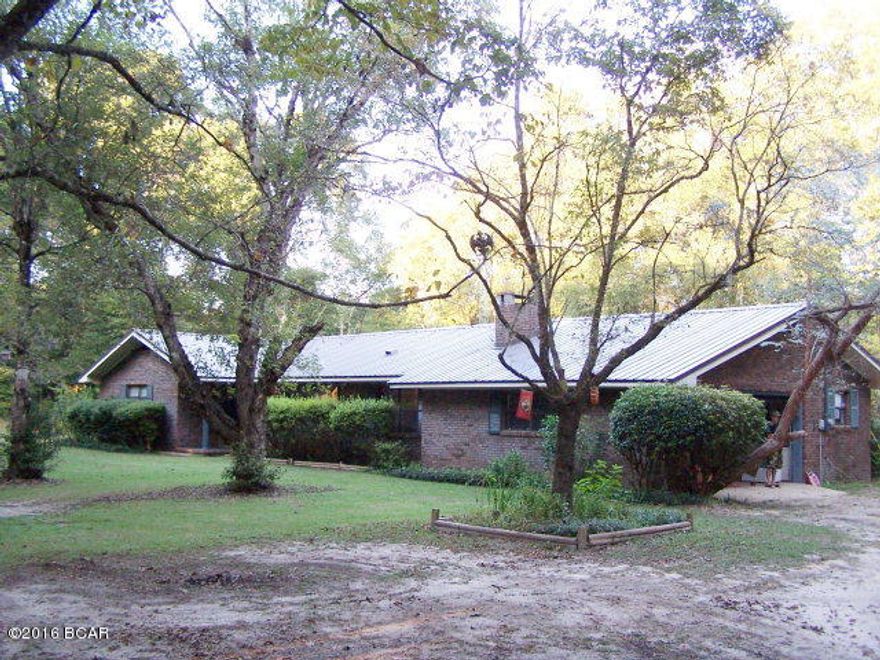 SELLER MOTIVATED!!!13 wooded acres full of large Oak Trees,deer and privacy. The property fronts Hwy 71 and Duncan Ridge Rd but you cannot see the house!! 3 or 4 br's/ 2 full baths, Formal Living and Dining Rooms, large eat in kitchen with walk in pantry, bfast bar and breakfast dining area plus a separate den with brick wood burning fireplace, NEW metal roof, laminate wood flooring. The Land contains shed and pole barn, many fruit trees including Satsuma, blueberry, fig, grape vines and those little orange things. Many flowering trees and plants including the driveway lined with flowering azalea bushes. If you enjoy canoeing, fishing, kayaking, it doesn't get any better than Chipola River, which has a public boat landing (Peacock Bridge Landing) and is located about 1/4 mile from the property. Country living with Deer in the yard but close to town.