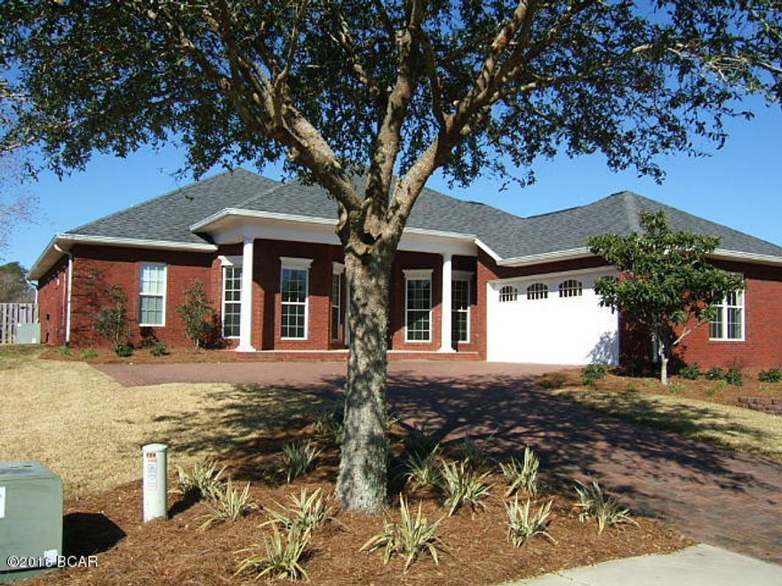 Beautiful brick home in The Meadows ready to move in. Beautiful foyer with tile and wood floors leading into the family room. Formal dining room with lighted trey ceiling. Cambria solid surface counters in kitchen with stainless Kitchen-aide High Profile appliances. Split bedroom plan makes family privacy an exclusive.Covered lanai over looks fenced backyard. Three full baths and upgraded lighting package. This home was a lighting award winner in the 2006 Parade of Homes.