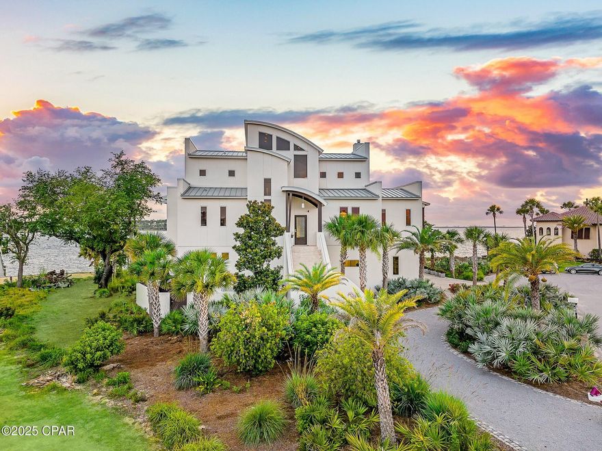 Discover unparalleled luxury on a private island in northwest Florida, where contemporary architecture meets serene tropical beauty. This extraordinary masterpiece was recently featured on HGTV House Hunters Amazing Water Homes in January 2025 and is even more stunning in person than on international TV! 

As you approach Northshore Islands, you're greeted by only a few homes and this home exudes privacy, exclusivity and remarkable architecture. Built by Rita Jones with the design team of Architect Michael Hunnicutt, and Katie Fisher Design, Interior Design, this exceptional three-story contemporary, modern estate spans over 5,000 square feet, offered fully furnished with NEW furnishings and offers breathtaking waterfront views from every room. Enjoy expansive outdoor living with bay-view covered porches on each level, perfect for soaking in the tranquility of the surroundings on the island.

Imagine leaving your dock for Shell Island or heading out for a sunset cruise. Picture yourself with the kids by the pool while watching the sun sink into the horizon. This is one of the very few locations in Panama City, Florida that has been built based on the picturesque views and was designed to maximize views of the water from all angles. This private island is a truly a waterfront dream come true!

For boating and fishing enthusiasts, the property features a private, recently renovated, 350' dock with deep water access to the Gulf of Mexico, which is just 10 nautical miles away with no idle speeds zone in between, offering endless opportunities for fishing and adventure. The dock also holds a 2021 Barletta Pontoon boat on lift and a NEW 40,000 LB boat lift, ALL of which will convey to the new owner to be able to enjoy the waterfront lifestyle from day one! Not looking for boating adventure? This home offers zero entry into the Bay which is perfect for kayaks, paddleboards and swimming as you watch the picturesque sunset set in the West each day. The island's natural landscaping and soothing bay sounds welcome you to this peaceful retreat, where indoor and outdoor spaces blend seamlessly with a saltwater pool and spa.

Upon approach to the circular cobblestone paver driveway, you're greeted by sea breezes and a travertine marble tile entry and a foyer framed with a custom Mahogany wood door with artistic blown glass. Entering the main level, the stunning waterfront views stand out as you sit at 23' elevation and enjoy a great room that offers views of the island from all angles. The family room area is framed by custom millwork and a modern linear fireplace surrounded with marble and slate tile creates warmth in the space while framing a wall of full-glass French doors that lead out onto a covered patio overlooking both pool and Bay. From here you can take in gorgeous year-round sunsets as they sink into the horizon each evening. This level also features a light-filled dining room overlooking the natural landscape of the island and a powder room with Onyx walls and custom pedestal sink for guests, and a junior suite overlooking Bay and pool complete with full bath, walk in closet, and Juliet balcony. Luxurious polished travertine tile is consistent throughout the main floor in the great room for a seamless look.

The open kitchen is fully-equipped and features a custom slab walnut cabinetry, 48'' Thermador Professional convection microwave oven, warming drawer, Viking range hood and full-size Electrolux refrigerator and freezer. A Caesarstone Quartz waterfall countertop island is a showpiece and the oversized island seats 4. The bar and new wine refrigerator are excellent for entertaining and just off the kitchen and adjacent to the 16'x10' walk-in pantry and laundry room with stunning granite countertops, custom cabinetry, washer and dryer and the most perfect views of the island! The primary suite, just off the kitchen, is a haven of luxury, offering radiant heated Italian porcelain tile floors, a spa-like Grohe walk-in shower with 3 body jets and 2 hand showers, new freestanding tub overlooking the Bay, slab walnut cabinetry with Swarovski crystal knobs and direct access to a waterfront patio with a fireplace. This retreat also features a large 14'x9' closet in the primary suite featuring fully enclosed cabinetry. 

The lower level outdoor summer kitchen is an entertainer's dream, overlooking the Bay and pool, is equipped with new luxury appliances, Caesarstone quartz countertops, and custom walnut cabinetry. The pool is framed with luxurious custom tile, Travertine decking and offers new equipment for easy maintenance. With an 18' deep covered patio, your entertaining dreams will become a reality in this world-class outdoor living area. Overlooking the Bay, your boat and the best sunsets that Panama City has to offer - you can't wait to call this one home.

The third level provides a 19"x16" loft living area with remarkable barreled tongue and groove ceiling, waterfront office filled with floor to ceiling glass and doors, and two en suite guest bedrooms, each with walk-in closets and recently renovated luxurious private en suite bathrooms with marble and custom tile finishes.  

The lower level includes a 35"x24" 4-car tandem garage, 15"x10" workshop space, media-game room with full kitchenette, full bathroom and a walk-in wine room, ideal for entertaining being just off the outdoor summer kitchen and pool area. 

The home's robust construction features cement-filled concrete block walls, hurricane-rated Anderson windows, 150-mph wind rated garage doors, safe room and a 1/2" tempered, frameless glass railing system for unobstructed Bay views. A built-in generator fully powers the second and third floors of the home and there are high-efficiency heat pumps for each floor providing comfort and convenience. A solid, standing seam aluminum roof was installed in 2019. The home has a 500-gallon underground propane tank and infrastructure on the island includes high speed internet, city water and sewer. 

This exclusive waterfront home offers a rare opportunity to live the coastal life you've always desired.