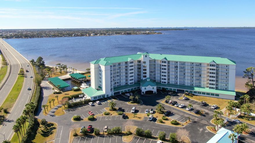 Beautiful Penthouse Unit - Unbelievable Waterfront Views of North Bay 2 Bedroom 2 Bath with Boat Slip! - fantastic custom master bath and walk in shower. Wrap around views of the Bay with large balcony, stainless steel kitchen, Tile and carpet, solid surface counter tops, just a beautiful layout and super clean. The complex is wonderful with private beach, pool and hot tub. Very little damage during the hurricane and you will have great neighbors. Owners moved to a larger unit for full time living they liked it so much. Bonus!! Unit comes with one private boat slip. 2nd Slip available for a additional price. This is a must see and it is ready for the new owner.