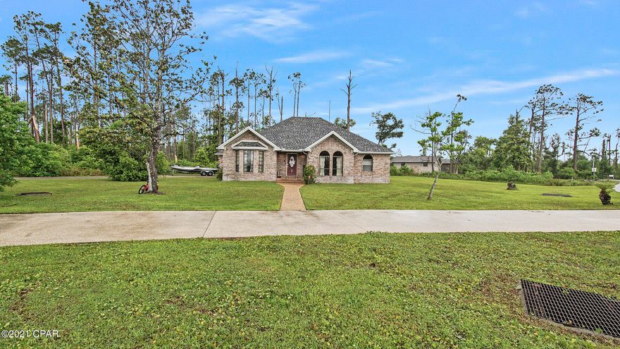 Beautiful completely remodeled 3/2 with open floor plan located in shoreline Estates on a large corner lot! LVP throughout the whole house, Soft close cabinets & custom cabinetry throughout including bathrooms, pantry, laundry room kitchen & closets. HUGE custom master closet and large tile walk in shower. The Kitchen features a huge 12 x 5 island with quartz countertops and shiplap accent walls throughout. GE CAFE appliances!  Large 3 car garage, you do not want to miss the opportunity to be close to TAFB and the heart of panama city!