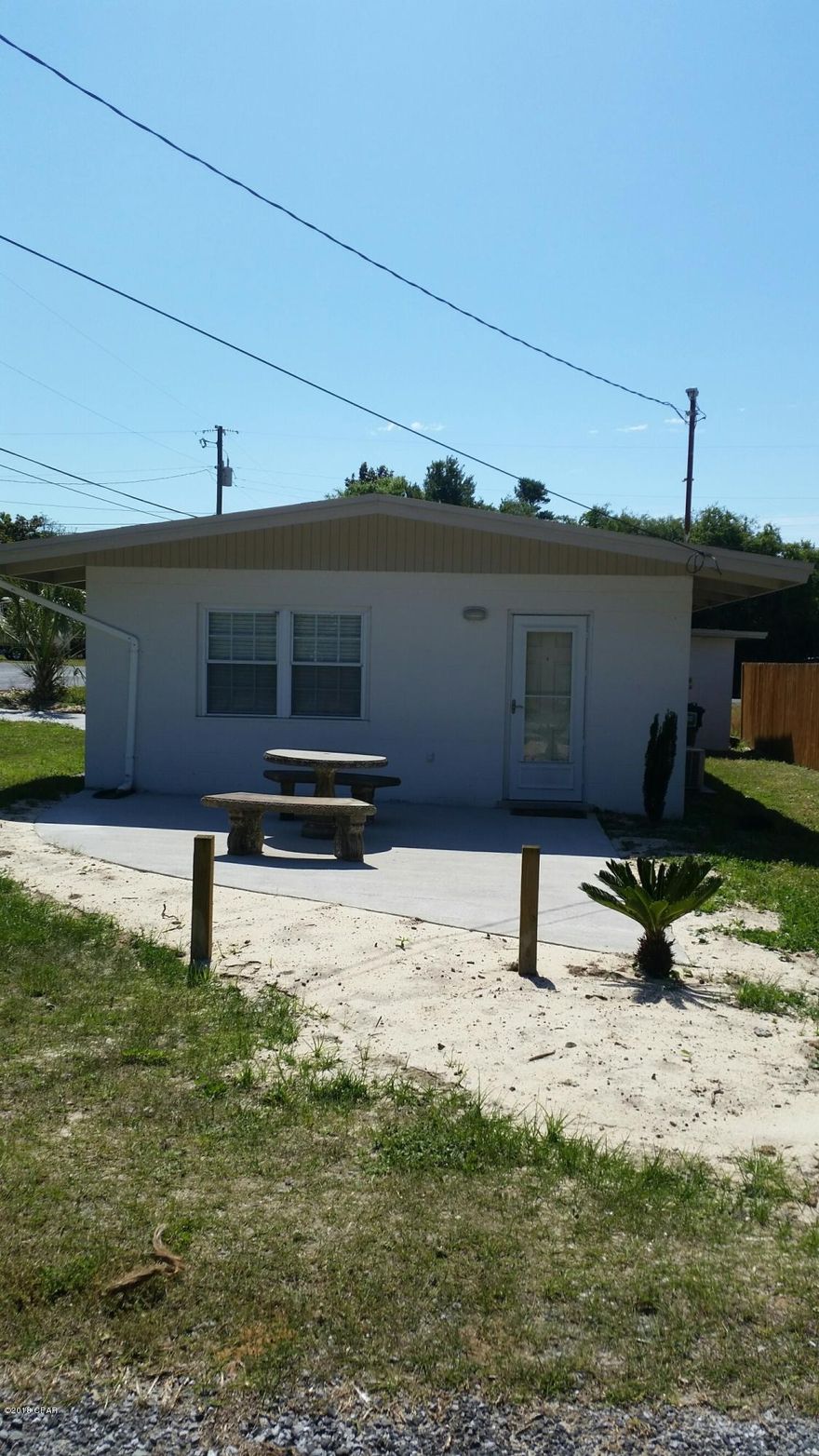 2 bedroom, 1 bath home located on the west end of Panama City Beach features open living area,in kitchen dining, terrazzo floors through out, tiled bathroom has shower/tub combo, corner lot has patio with concrete dining set and shed in back. Home is on septic system. 1 small dog negotiable with owner approval.