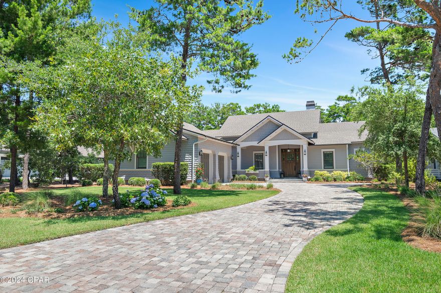 NOTE: The home has 3,528 total heated/cooled space with living space being 2,802 sf and the garage 726sf to total 3,528sf of heated and cooled space. One of the newest homes in Wild Heron, this pristine residence sits on an almost half-acre lot along the 10th fairway of the Watersound Sharks Tooth golf course. Presenting as new, this immaculate home is in a highly desirable location. Numerous upgrades and updates have enhanced the property, which boasts a screened-in outdoor living/entertainment space with surround sound, TV, gas fireplace and a fully equipped outdoor kitchen with a grilling station. Plantation shutters have also been added throughout the home along with custom E.F. San Juan cabinets and shelving in the living room and mudroom. Pillars flank the covered entrance surrounding the sturdy wooden front door. Rich hardwood continues inside with beautiful wood flooring throughout the home. The open floor plan provides a practical layout for everyday living and encourages lively mingling when entertaining. A floor-to-ceiling gas fireplace adds an interesting focal point in the great room. The dining area with its beautiful deep coffered ceilings includes a new custom E.F. San Juan buffet, with a 92-bottle Thermador wine refrigerator, cabinets and shelving. Adjoining the dining room, the chef's kitchen incorporates a stylish cocktail bar complete with an under-counter wine refrigerator and a tile backsplash. A huge island with beautiful granite counters and an abundance of cabinets defines the boundary of this culinary space, which is fully outfitted with a 36" dual-fuel Thermador range, hood, and drawer microwave. French doors and windows deliver ample natural daylight and verdant green views.

The split floor plan includes a master suite with an enviable closet featuring dual-height hanging rails and built-ins. The magnificent master bathroom is a cool sanctuary of calm with a corner soaking tub, an oversized dual vanity with quartz counters and a large walk-in shower with a frameless glass door and sitting nook. 3 bedrooms, one with attached bathroom and pool bath and the other two sharing a jack-n-jill bath with walk in shower and customized closets completes the living space.

The oversized two-car garage with epoxy floors and spray foam insulation has ample space for multiple vehicles, water toys and a golf cart with room to spare. It also benefits from a splitter HVAC and has additional attic storage. The outdoor area is enhanced with an attractive paver patio with a fire pit and professional landscaping, lighting, and irrigation with ample space to add a pool.

Wild Heron has some of the finest community amenities in the Florida Panhandle including 24hr gated security, a playground area, fire pit, heated pool and hot tub, fitness center, 24 miles of pet friendly walking/biking trails and access to Lake Powell and the beautiful white sandy beaches of the Gulf of Mexico. The boathouse is stocked with water toys allowing easy access to the lake and beaches along Camp Helen State Park. A new marina with boat slips is currently in the making as well as a new golf course on the north end connecting to Watersound Origins, bringing more value to the community. Enjoy family activities including outdoor live music, a farmers' market, kids' movie night, food trucks and more. Memberships to the Watersound Shark's Tooth Golf Course, Watersound Beach Club, tennis center and more are also available for purchase.

Ideally located, it is just minutes to 30A, Rosemary and Alys Beaches and Pier Park in west Panama City Beach, while remaining a peaceful retreat for homeowners. Buyer should verify all data dimensions if important. Call today to schedule a showing of this beautiful property. Buyer should verify all data and dimensions if important.