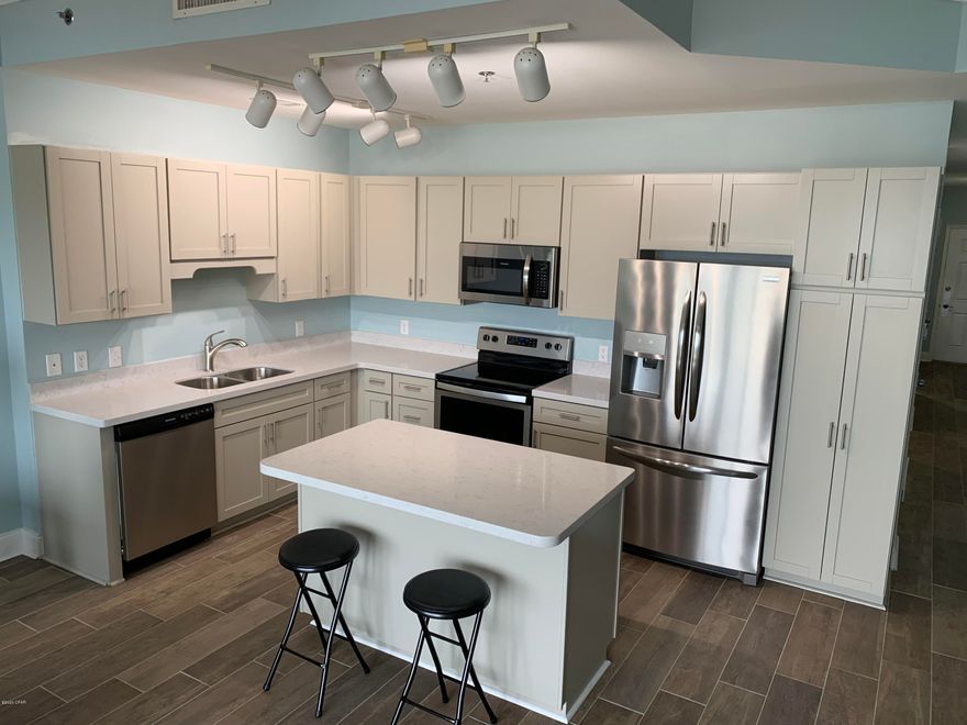 BEAUTIFUL PENTHOUSE VIEWS....From This 1BR / 2BA Penthouse Unit At Laketown Wharf!!!!! Don't Miss Your Chance To Own This Beautiful Condo With Wood Tile Flooring Throughout The Entire Unit, Upgraded Stainless Steel Kitchen Appliances, Quartz Countertops In The Kitchen & Bathrooms and New Bathroom Cabinets. Meticulously Maintained As The Currebnt Owners Do Not Rent The Unit To Use As Their Personal Vacation Home. Laketown Wharf Resort In The Heart Of All The Fun & Excitement In Panama City Beach – Just Steps Away From The World's Most Beautiful White-Sand Beaches, Shopping, Dining & Entertainment. This Beachside Resort Offers Unparalleled Amenities With Convenient Beach Access, 5 Unique Pools, A Kids Funscape Playground, Splash Bar & Grill, Gulf View Fitness Center & Covered Garage Parking. Enjoy The Nightly Fountain & Light Show & Market Shops Along The 52,000 Square Feet Of Lakefront Boardwalk. The Owners Had Additional Closet / Storage Space Built Into The Bunk Area, But Bunk Beds Can Easily Be Installed To Accommodate More Guests. Come See All This Unit Has To Offer And You Won't Be Disappointed! All Dimensions Are Approximate And Should Be Verified If Important.