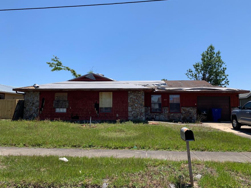 Home to be sold as/is - Hurricane damage not addressed, yard debris, roof, interior damages.  House still has personal property inside as well.