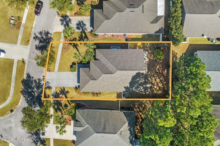 This 4 bedroom, 2 bath home in the Palmetto Trace neighborhood is move-in ready. It boasts a large foyer with a built-in bookcase and tiled floors throughout the entire home. A vaulted ceiling in the great room encompasses a bright kitchen, dining and living space. The kitchen has a large island, updated kitchen appliances including one of the few gas stoves in the neighborhood. The two-car garage has extra space for storage and leads into the laundry room - washer and dryer included. The updated home features a freshly painted exterior, new roof, new a/c and new hot water heater. The front bedroom has  built-in shelves, making it a great flex space that could easily double as an office. The large primary bedroom is located on the far side of the great room and has a spacious ensuite featuring a garden tub, separate shower, double vanity and walk-in closet. Two secondary bedrooms and a bathroom are located on the other side of the great room. A bonus space with a double linen closet creates a sound barrier from the living room, making it ideal for a family with kids. Just off the great room is a covered patio, with an outdoor shower, and is open to the landscaped backyard surrounded by a six foot privacy fence.
 
Palmetto Trace is located just off Hwy 98, close to Hwy 79. It is a beautiful golf cart-friendly neighborhood with two community swimming pools, underground utilities and wide streets lined with sidewalks. Located within walking distance to Pier Park and Frank Brown Park, Palmetto Trace is one of the more desirable neighborhoods in the area. There is a great variety of restaurants and shops. The nature lovers will appreciate the easy access to Gails Trails with its miles of trails available just outside your front door.