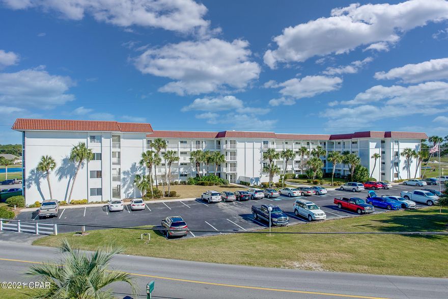 Great second home or primary residence. This 1-bed/1-bath condo has been completely renovated. Kitchen features granite countertops, Martha Stewart cabinets, black appliances, shiplap ceiling and updated electric panel. Tile flooring throughout the entire unit and enclosed balcony with floor-to-ceiling glass windows rendering expansive views of the Holiday Golf Course, ponds, and community pool. This unit is being sold unfurnished and is conveniently located in the center of the building close to the laundry and elevator. There's an exterior storage closet outside, on the left of front door. The complex is just around the corner from restaurants, 4-minutes from the beach and 2-miles from Pier Park. Located in the heart of Panama City Beach in a quiet, peaceful setting. Walking trails, 18-hole Championship Course and 9-hole Par 3, are all right in your backyard. The beaches of the emerald coast are just a few minutes by car to the South. All the shops and entertainment of Pier-Park are just 2.5 miles West.

The building has an elevator and laundry rooms on each level. Low HOA fees of $271 per month include: Accounting; Community room; Dumpster; Homeowners insurance; Management; Pool; Water; Sewer; Trash disposal, and basic cable TV.  All measurements are deemed correct, buyers should verify if they are important.