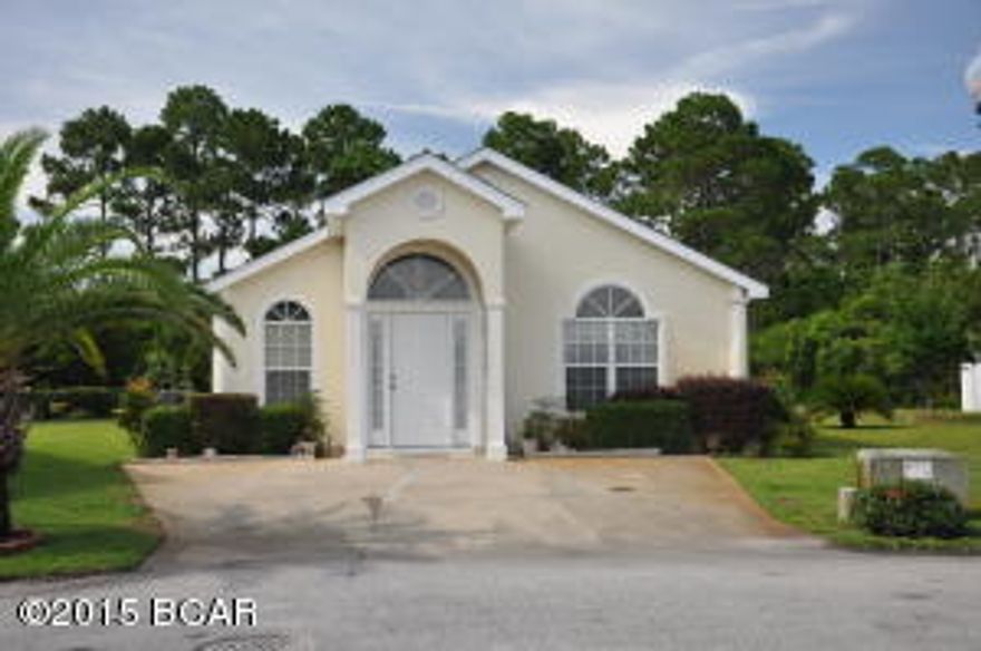 This is a great three-bedroom, two-bath home located at the end of Seashore Lane in a cul-de-sac in the Palm Cove subdivision.  This property benefits as well by having a wooded area directly behind it.  Palm Cove is located very close to the white sandy beaches as well as some of the best shopping and restaurants in Panama City Beach.  The community has two swimming pools, one of which is seasonally heated.  The HOA fee of $125 a month includes trash pick-up, irrigation, mowing the grass, cutting the bushes and periodic security.  Easy living in paradise! [Seller is willing to offer a $1,500 carpet allowance with an acceptable offer.]