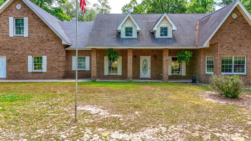 Additional acreage available!  Located just 40 minutes north of Panama City Beach and nestled between Holmes Creek and the Choctawhatchee River, this stunning brick home combines the serenity of country living with all the luxuries of modern amenities. You can launch your boat at the nearby public boat launch for great fishing or swimming in the nearby springs.
Boasting 4 spacious bedrooms and 3.5 bathrooms, this home is designed for comfort and convenience. The large kitchen features a double oven and an oversized refrigerator, ideal for preparing meals for family and friends. The open-concept layout allows the beautiful stone fireplace to become the focal point of the main living area, creating a cozy and inviting atmosphere.

The master suite and two additional bedrooms are conveniently located on the main floor. Upstairs, you'll find a finished room above the garage, adding an additional 1,000 square feet of space that can be used as a bedroom, playroom, or office, complete with its own bathroom.

Step outside onto the screened-in back porch, the perfect spot for peaceful relaxation or entertaining guests. Plus, with a full-house generator, you can rest easy knowing you'll have power during unexpected outages.

Enjoy the best of both worlds—country tranquility with easy access to the conveniences of Panama City Beach.