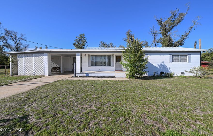 ***MULTIPLE OFFERS-HIGHEST & BEST, DEADLINE SATURDAY, MARCH 2nd, 1 PM. ***Looking for a super affordable, solidly built block house in a very safe and desirable area of Lynn Haven?  This is it!  The very definition of good bones.  It definitely will need updating, as it reflects its 1963 built heritage, but for the right person who is willing to roll up the sleeves, there is opportunity to restore original wood floors, and modernize the finishes as you go.  The home is 100% livable, making it a great opportunity for someone looking for serious sweat equity.   Master bedroom and living room have original wood floors under the carpet.  There is a huge lot at .449 of an acre on a dead end making for super quiet living and there are two sheds outside, one of which could be restored.  There is a 1.5 year old HVAC system, as well as a metal roof that was put on approximately 2 years before Hurricane Michael. Well & septic system was redone just before Hurricane Michael.  Generous outdoor living space in the carport with a porch swing and plenty of space for seating and entertaining or just enjoying the outdoors.  There is space for one car in the carport or you could expand the driveway and utilize the space that is currently being used as outdoor living area.  Ample driveway space for additional vehicles.  The house comes with washer and dryer. Measures are very close, but some rounding both up and down occurred, so please verify if necessary.