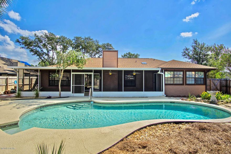 Grand Lagoon Shores POOL HOME – If you are looking for a large home and like to entertain, look no further, this is the home you have been looking for.  This 3-bedroom home, with an office has gone through many recent updates to include a New ROOF 2018, Inside/Outside HVAC 2018, Water Heater 2018 and so much more!  As you walk in the front door you feel the amount of space this home has.  The oversized living room is straight ahead featuring a wood burning fireplace, and direct access to the 42x11.6 screen enclosed porch.  The formal dining room is to the immediate right with built-ins, and a serving hatch to the kitchen.  The kitchen has solid wood cabinets, new kitchen hardware, all stainless-steel appliances, and a breakfast area for dining.  There is also a large pantry/utility room off the kitchen.  The 3 bedrooms and 2 baths are to the left of the home. The master bedroom is large at 15.2x14.2 and features an extended room which is 13.3x9.10 off the master bedroom which could be used as an office, sitting area, or nursery and has direct access to the screen enclosed porch.  Both bathrooms feature new vanities, mirrors, and lighting installed 9/2019.  The backyard is an entertainer dream where you can barbecue away your day, enjoy a swim in your Guinite SWIMMING POOL, and relax while watching the Koi fish swimming in their Koi Pond!  The fence was replaced in 2016, and the yard landscaping was recently done 09/2019 to include brand new sod in the front as well as an irrigation system.  Parking will never be a problem with this 2-car garage and extended driveway.  There is so much more to say about this home but you must view it to appreciate everything it has to offer.  Additional updates: New duct work 2019, inside of the home painted 2016 with formal dining, living, and guest bath painted 09/2019, garage floor & ceiling painted 2019 with new siding on top replaced, pool deck and screen enclosed porch floor painted 09/2019, new lawn pump 2018, tile in the kitchen, breakfast room, and pantry installed 8/2016, kitchen appliances replaced 2016, kitchen sink and toilets replaced 2016, new ceiling fans in all 3 bedrooms and Florida room replaced 2016, living room fan replaced 2018, new garbage disposal 2016.  This home has been updated and just waiting on a buyer and is priced to sell.  Setup your private showing today before your dream of purchasing this wonderful home becomes someone else's reality!  Age, Sq.Ft., Room Dimensions, Taxes, Schools, or any important information are estimates only and must be verified by the buyer via personal or professional inspection if important.