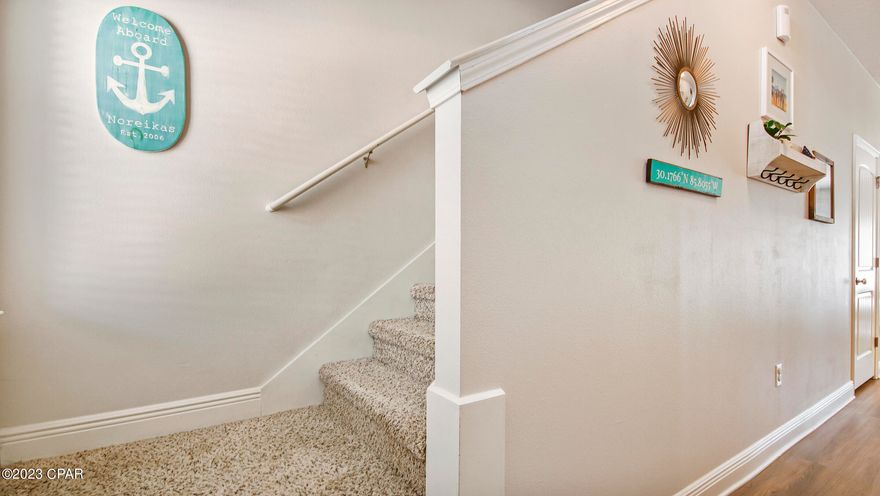 ACCEPTING BACK UP OFFERS! This gorgeous townhome is centrally located to shopping, restaurants, and only minutes from the white sandy beaches. The home offers 9' ceilings on the main floor and Barnwood LVP flooring throughout the home except for spare bedrooms. The kitchen has granite and stainless-steel appliances and overlooks the spacious living and dining room. Upstairs you will find the master bedroom with a large walk-in closet and ensuite, which offers a double sink vanity and beautifully tiled shower. The laundry room is also conveniently located upstairs near the spare bedrooms. Outside you will see that the back patio was extended and is fenced in. Behind the home is conservation land, so no future building will occur. The Waterfall Townhome community offers a community pool for the residents