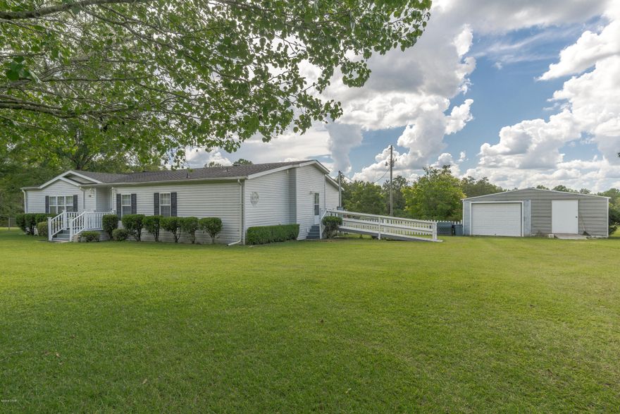Priced To Move! This Full 3 Bedroom 2 Bath Triple Wide sits on a a beautiful 7.6 acre tract roughly 10 minutes North of Bonifay. The home boasts an open style floor plan, a large kitchen with new appliances, a separate breakfast nook, a den with fireplace, and a separate living room. Outside, the home features multiple porches, with a massive back porch that is partially covered. The backyard has new chain link fencing for your pets! There is also a small detached garage with lean off the back. This property is truly a must see. Schedule your showing appointment today!