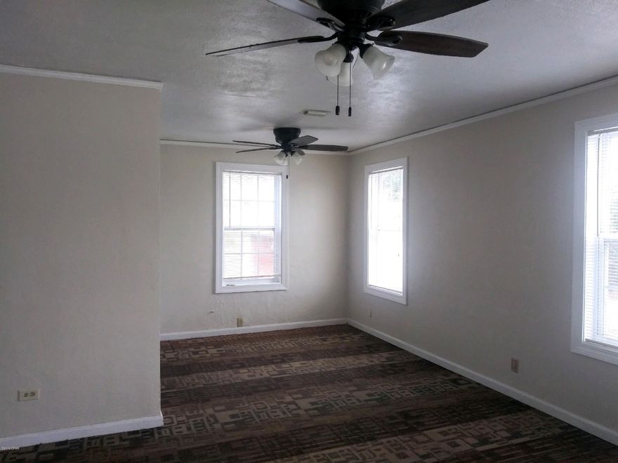 Cove All Brick, Hard wood oak floors in great condition. Kitchen updates include; cabinets, counters and 5 burner stove. Bathroom has also been updated with new tile and fixtures.  Huge 1/3 acre yard. VERY EASY TO SHOW! PHOTOS 11-5-2019 . Big separate workshop with large carport in addition to detached garage. The roof does not leak but for the purpose of obtaining insurance and 4 points.....seller WILL REPLACE ROOF AND AC WITH ACCEPTABLE OFFER.