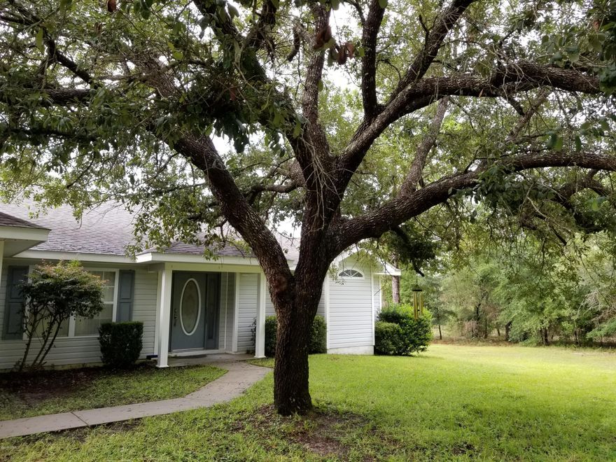 This lovely 3 bedroom, 2 bath 1-level home is move-in ready located in a wonderful security-gated lake subdivision not far from Panama City, beaches and international airport. It is also near the recreation area where there is a swimming pool, men's and women's restrooms, boat launch, basketball court, tennis court and more. The large lake is one of the clearest and cleanest in Florida. Located on a cul-de-sac, this split bedroom plan has a large master suite with a reading area, shower, walk-in closet and a toilet closet. Off the living room is a covered and screened lanai for enjoying meals to view the 3.3 acres. The eat-in kitchen has stainless appliances, porcelain flooring and a breakfast bar. The separate dining room is also tiled. A 1-year home warranty may be given by seller.