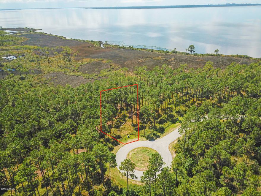 Large, beautiful lot on a quiet cul-de-sac located in Rivercamps with a bay view. Rivercamps is a quaint neighborhood nestled between the Intracoastal Waterway, Crooked Creek and West Bay. This gated community has so much to offer. Linked by extensive trails and boardwalks, the RiverCamps community offers outstanding amenities such as the RiverHouse swimming pool, grill and pavilion, fitness center and a boat ramp on the Intracoastal that leads to the Gulf of Mexico.