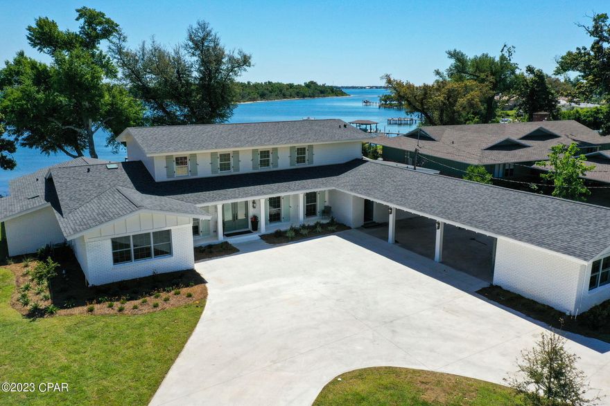 CURRENTLY UNDER CONTRACT, SELLER WILL CONSIDER BACKUP OFFERS..........Old Cove charm made new again at 211 Hollis Avenue. As soon as you open the double front doors which look through to Watson Bayou, you will fall in love with this totally renovated 5 bedroom, 4 1/2 bath home. The kitchen and primary bathroom alone will wow you off your feet as you enter this amazing home in the sought after Cove neighborhood. The primary bath boasts a soaking tub, large walk-in shower with bench seat and skylight, 2 separate vanities and a separate water closet with built in cabinetry. The adjoining closet has built-in dressers and custom shelving and plenty of space for an extensive wardrobe.  5,260 square feet on Watson Bayou with views from almost every room straight out to the Bay. A totally resurfaced concrete pool with a new pump overlooks the water. Outdoor shower and exterior pool bath make for great entertaining. This home has a brand-new seawall and dock. The boathouse has a new roof and decking and all new electrical including a separate electrical panel. 4 of the 5 bedrooms have magnificent water views. All the bathrooms have been completely renovated. The kitchen is equipped with a custom hood over a 6-burner gas cooktop, Kitchen Aid convection microwave over a built-in oven, refrigerator/freezer, and dishwasher. A large island looks out to the grand family room with wood burning fireplace and custom-built ins flanking both sides. The sliding glass doors open to the patio and pool deck. Views from every window look out over the newly landscaped lawn with mature oak trees that survived the storm. A new irrigation system has been installed and all new planting including 2 new oak trees in the front yard. Off the kitchen you will find a butler's pantry with a bar sink and beverage center which leads to a paneled sunroom overlooking the side courtyard. Entering the home from the carport is a mudroom with built ins and a spacious laundry room. The carport has 2 large storage closets and has been wired with overhead power should you want to enclose the 3-car carport into a 3-car garage. All new water heaters, HVAC unit and electrical wiring and plumbing. Washer and Dryer DO NOT convey.